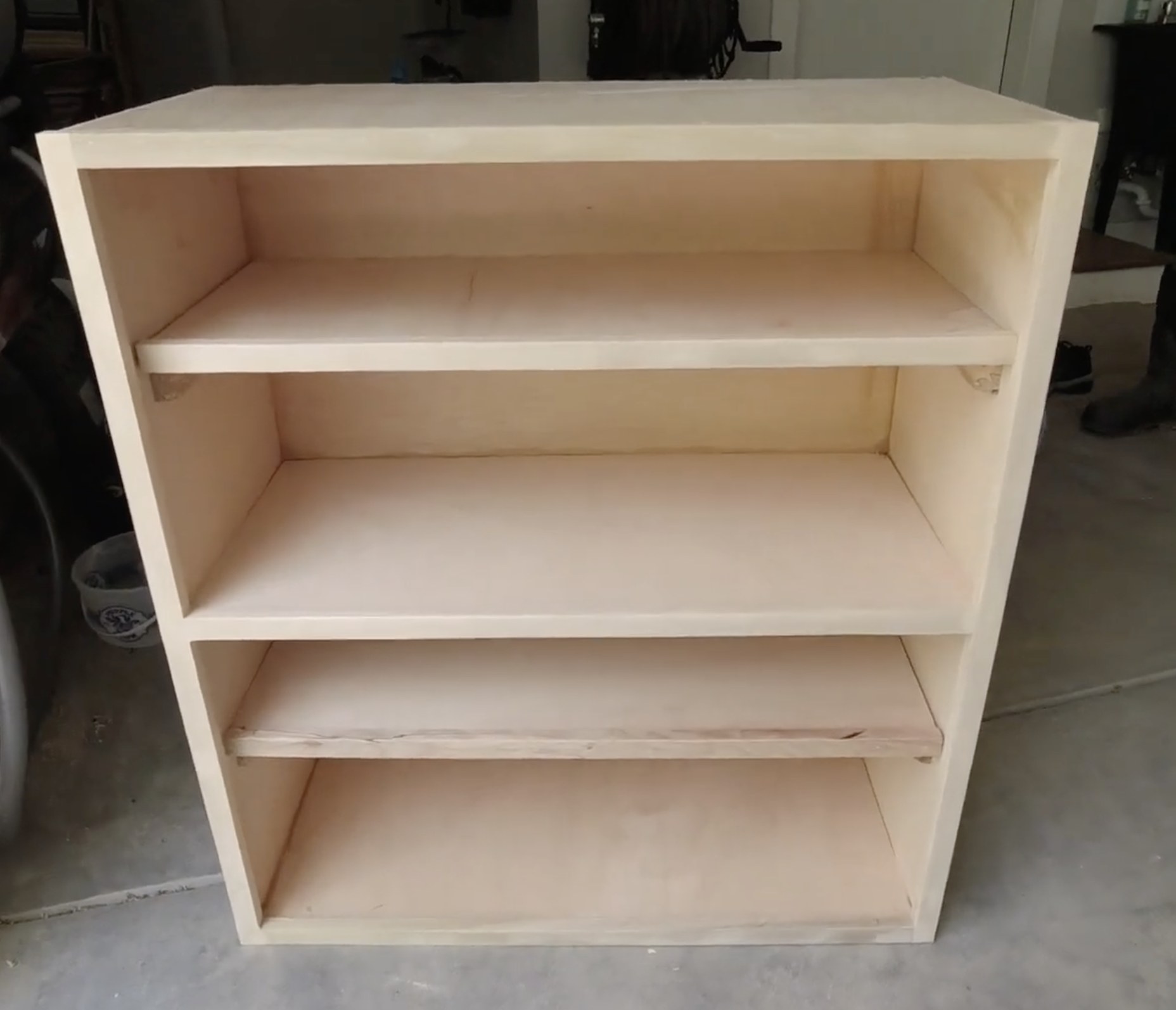 Simple plywood garage cabinet built from 3/4 inch plywood with face frame and shelves, in a garage workshop